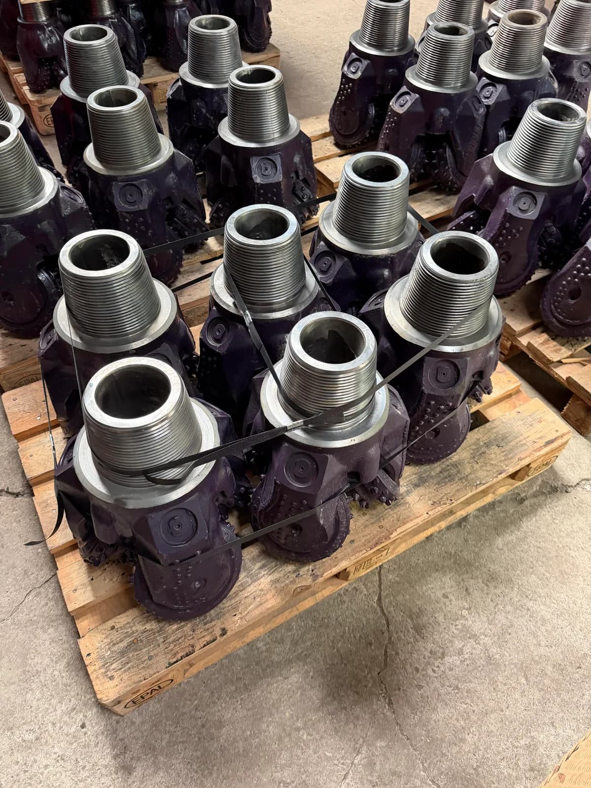 Tricone bits strapped to a pallet, ready for the forwarder